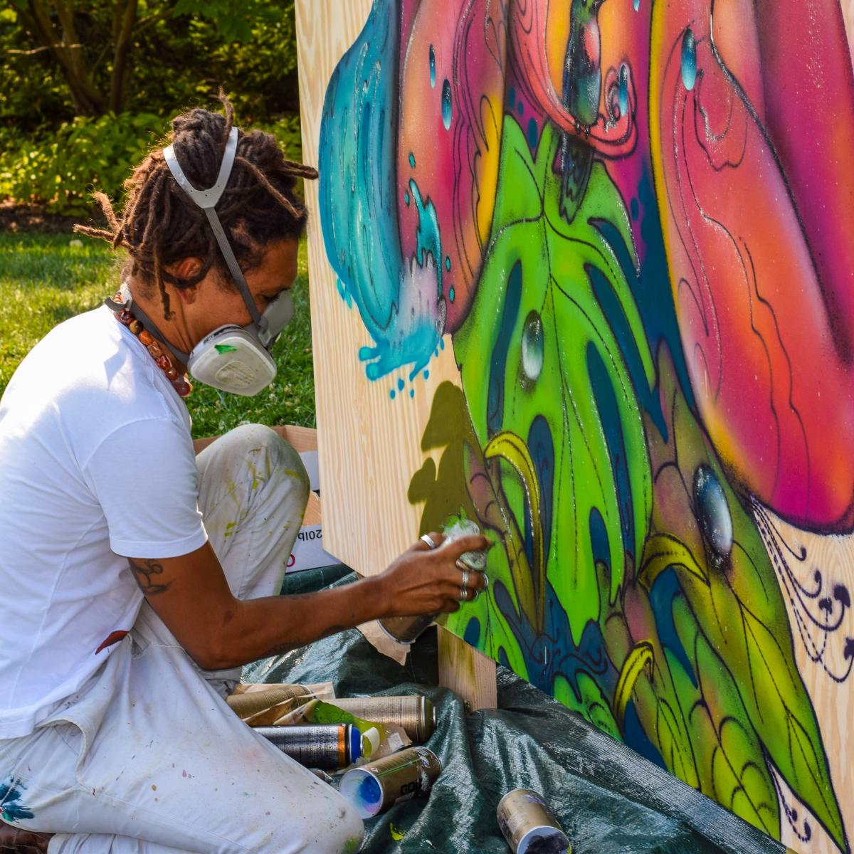Brazilian grafiti artist Eder Muniz paints a mural for the global education center