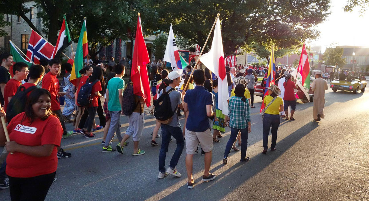 students marching in the international homecoming parade
