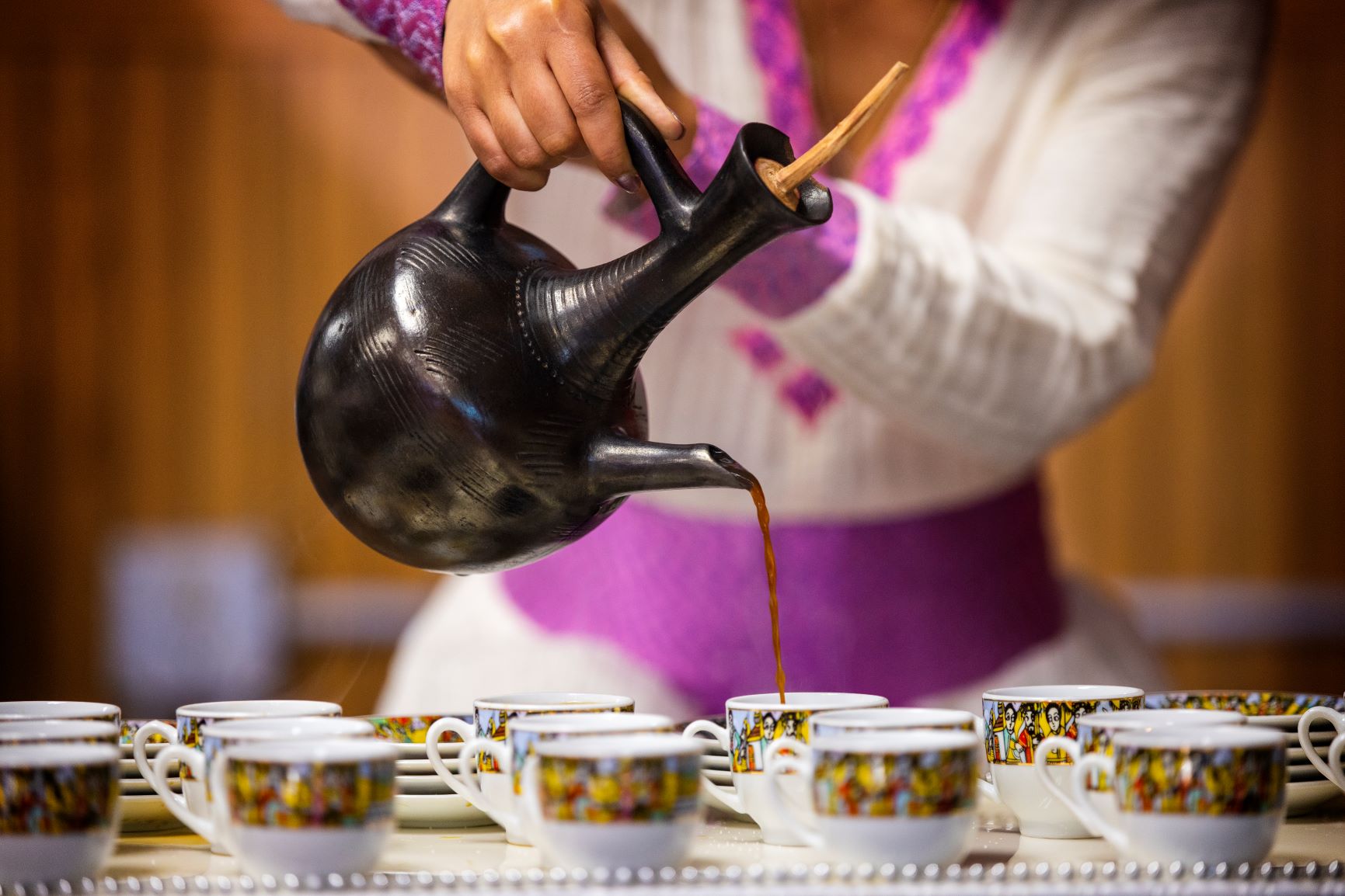 Woman pouring coffee for an Ethiopian coffee ceremony