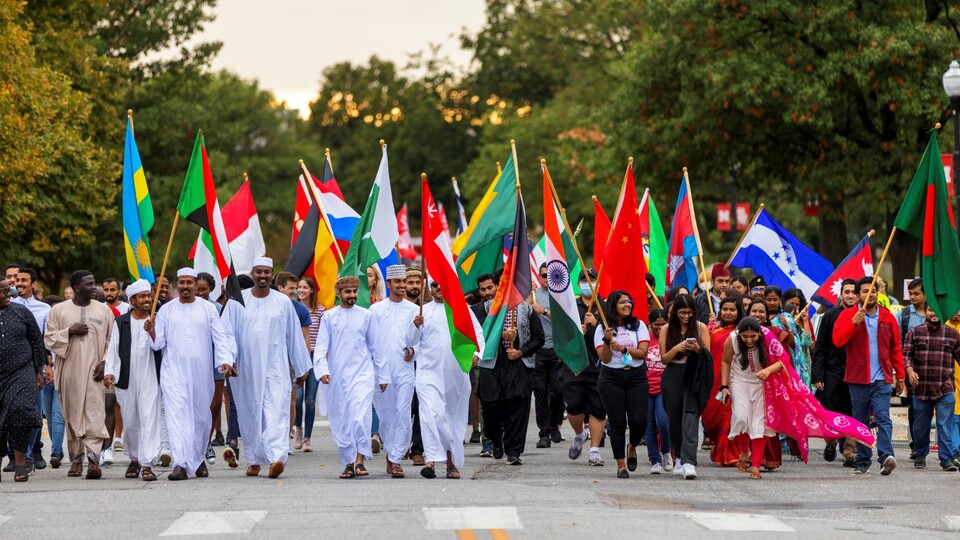 More than 100 international students marched under the flags of their nations