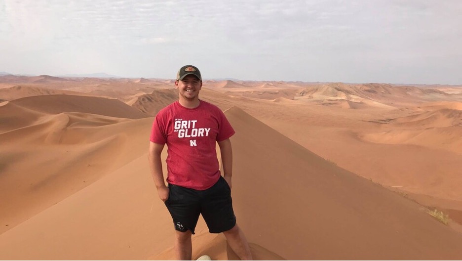 A Husker student stands on one of the tallest sand dunes in the world during a study abroad program in Namibia in 2019.