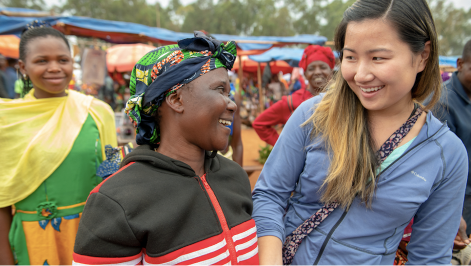 A Peace Corps volunteer talks to a community member in Tanzania. 