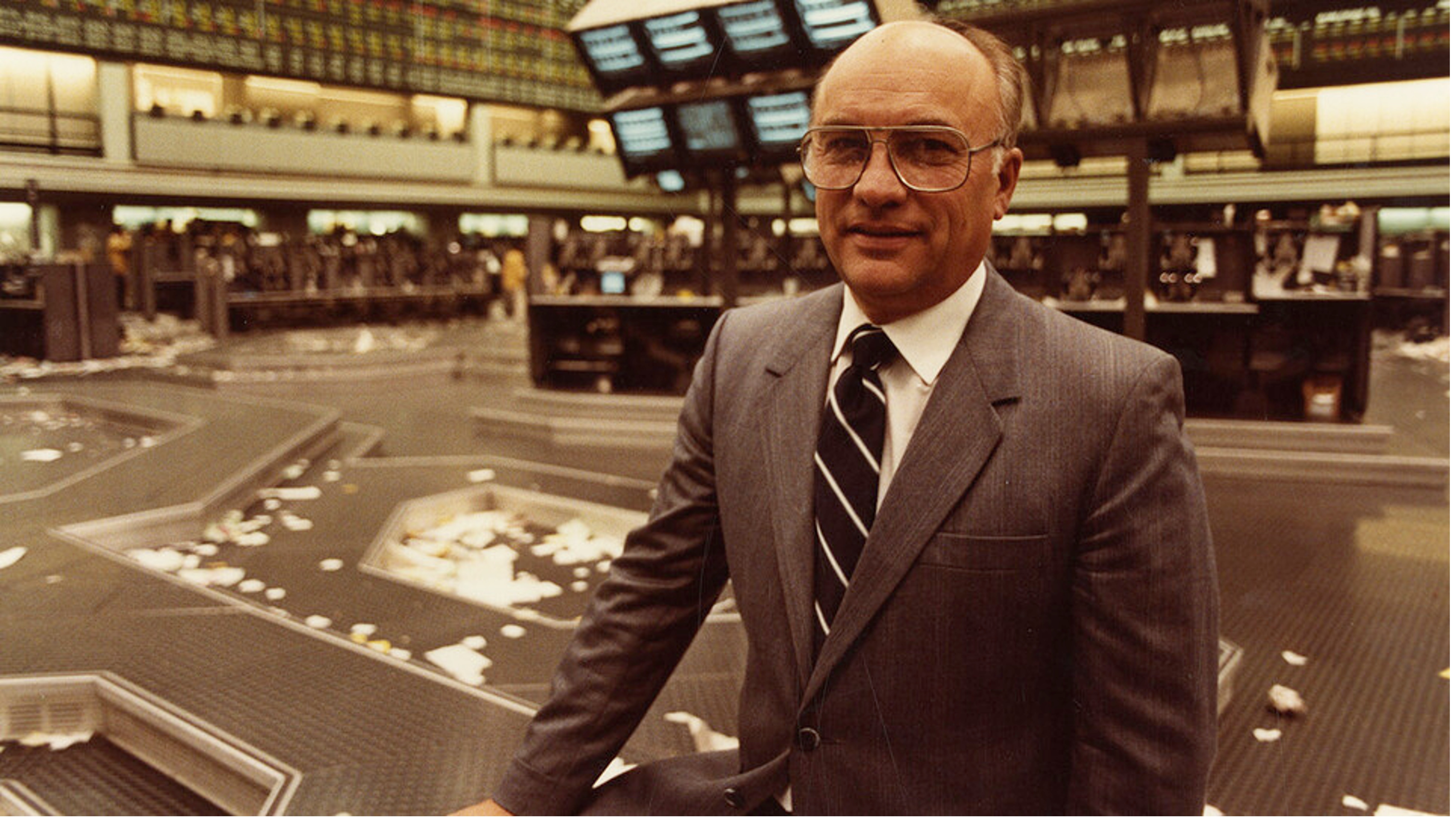Clayton Yeutter, former United States Secretary of Agriculture, stands inside a financial center building. 
