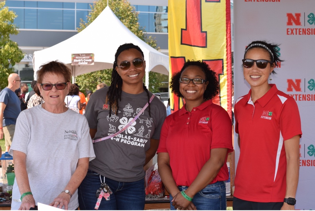 Nebraska Extension staff pose at the 2021 Afro Fest Omaha festival. It supports the festival by hosting a booth with community resources and partnering with Global Affairs to sponsor the event. 