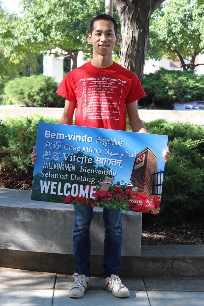 student holding welcome placard