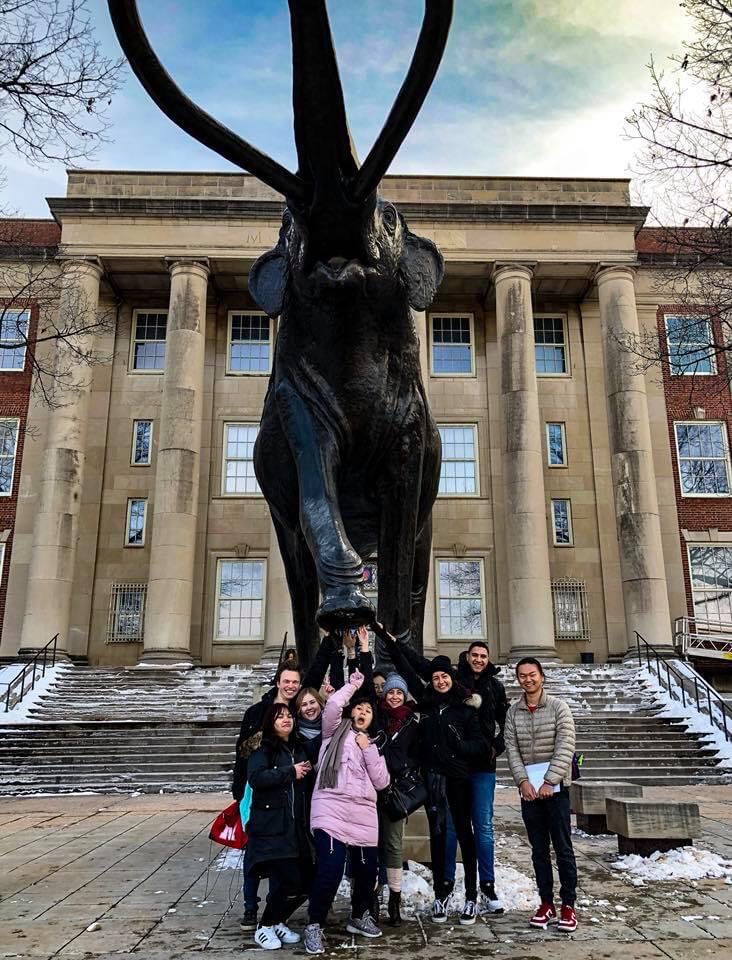 May Teoh with friends by the Archie the mammoth statue at UNL